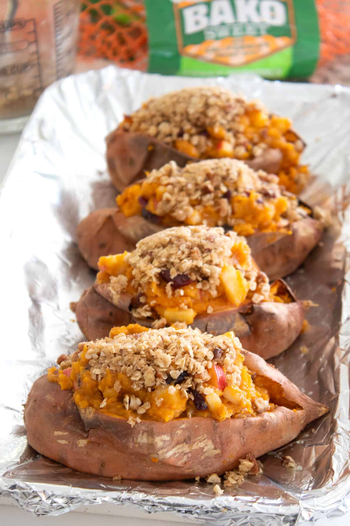 adding streusel topping to stuffed sweet potatoes