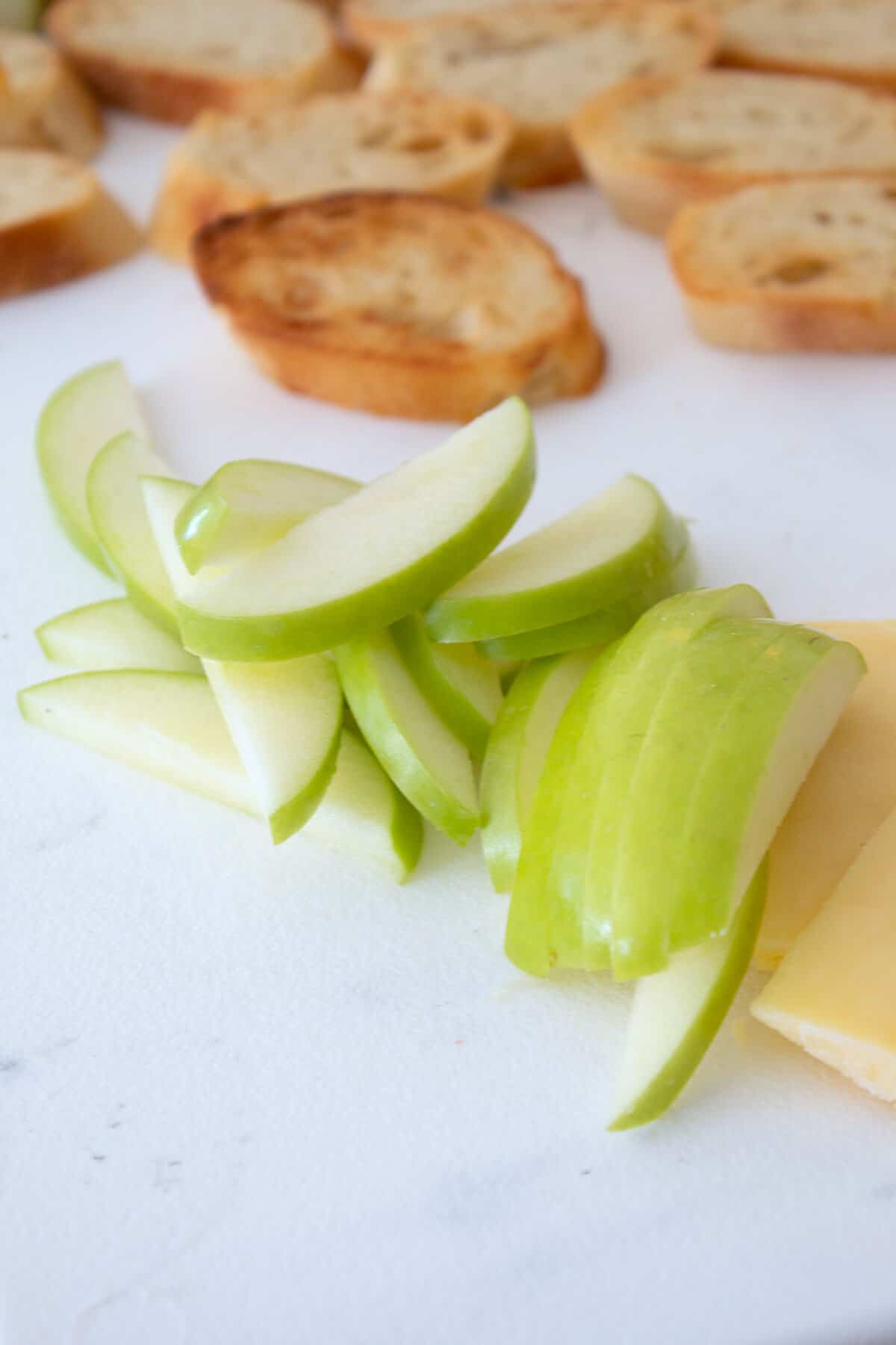 thin sliced apples on a cutting board