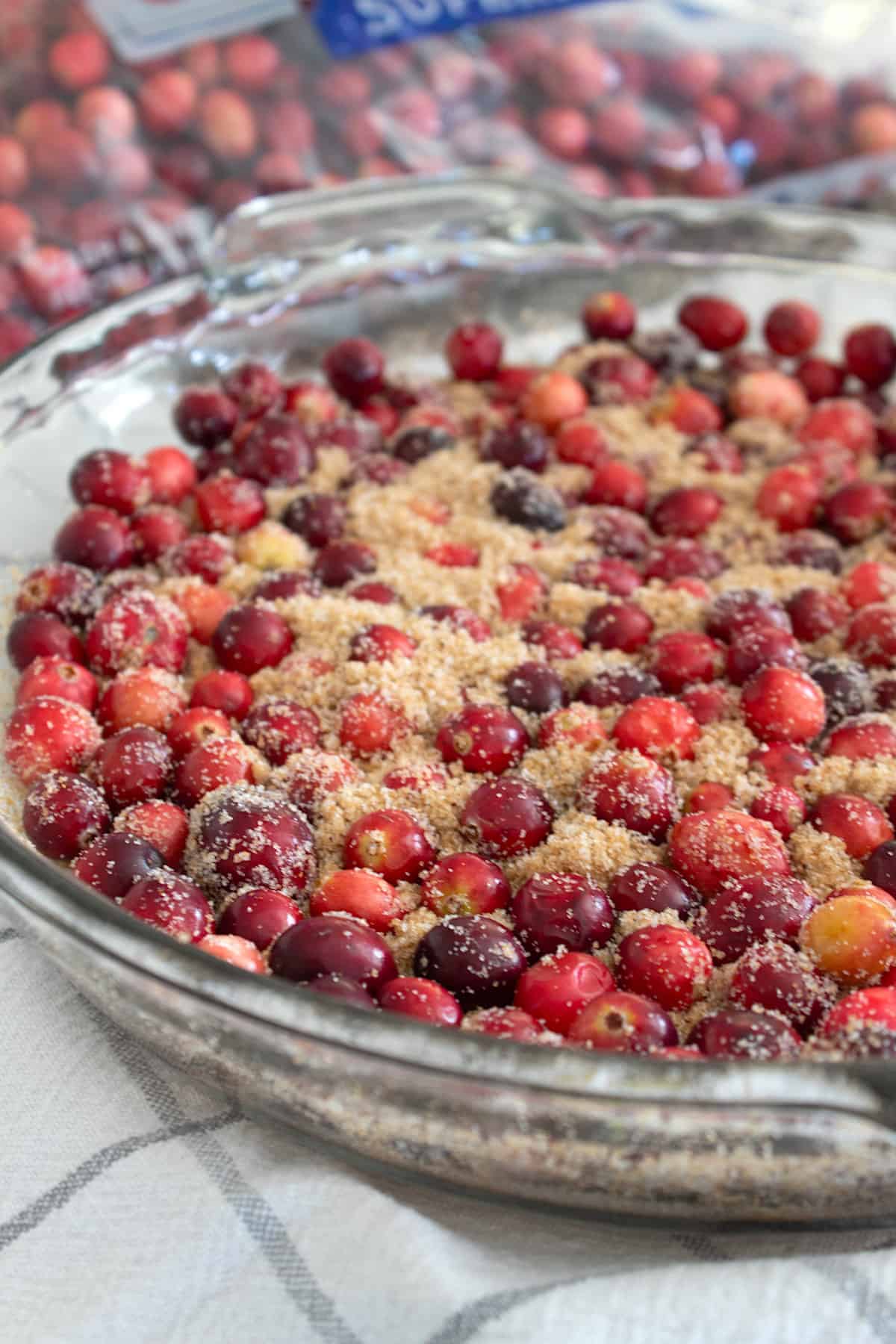 pressing down on cranberries in cake pan