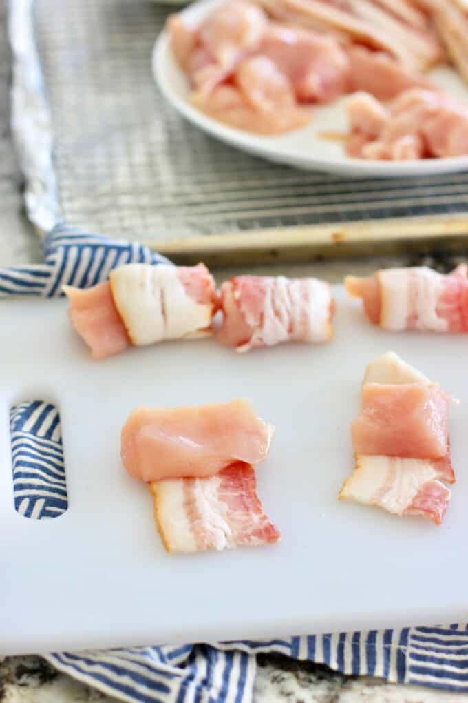 adding chicken to bacon and rolling up