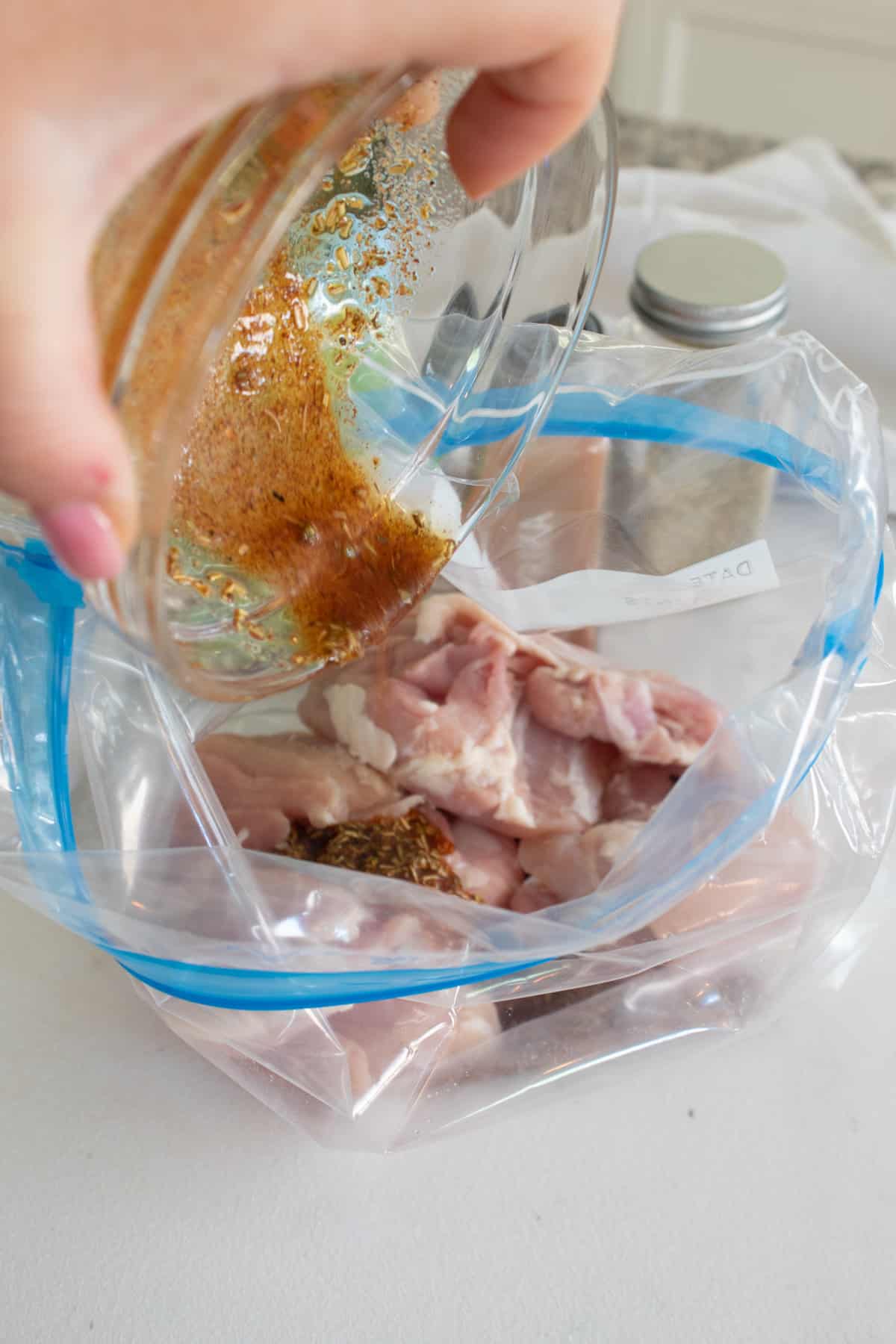 adding seasoning and chicken to bag to mix