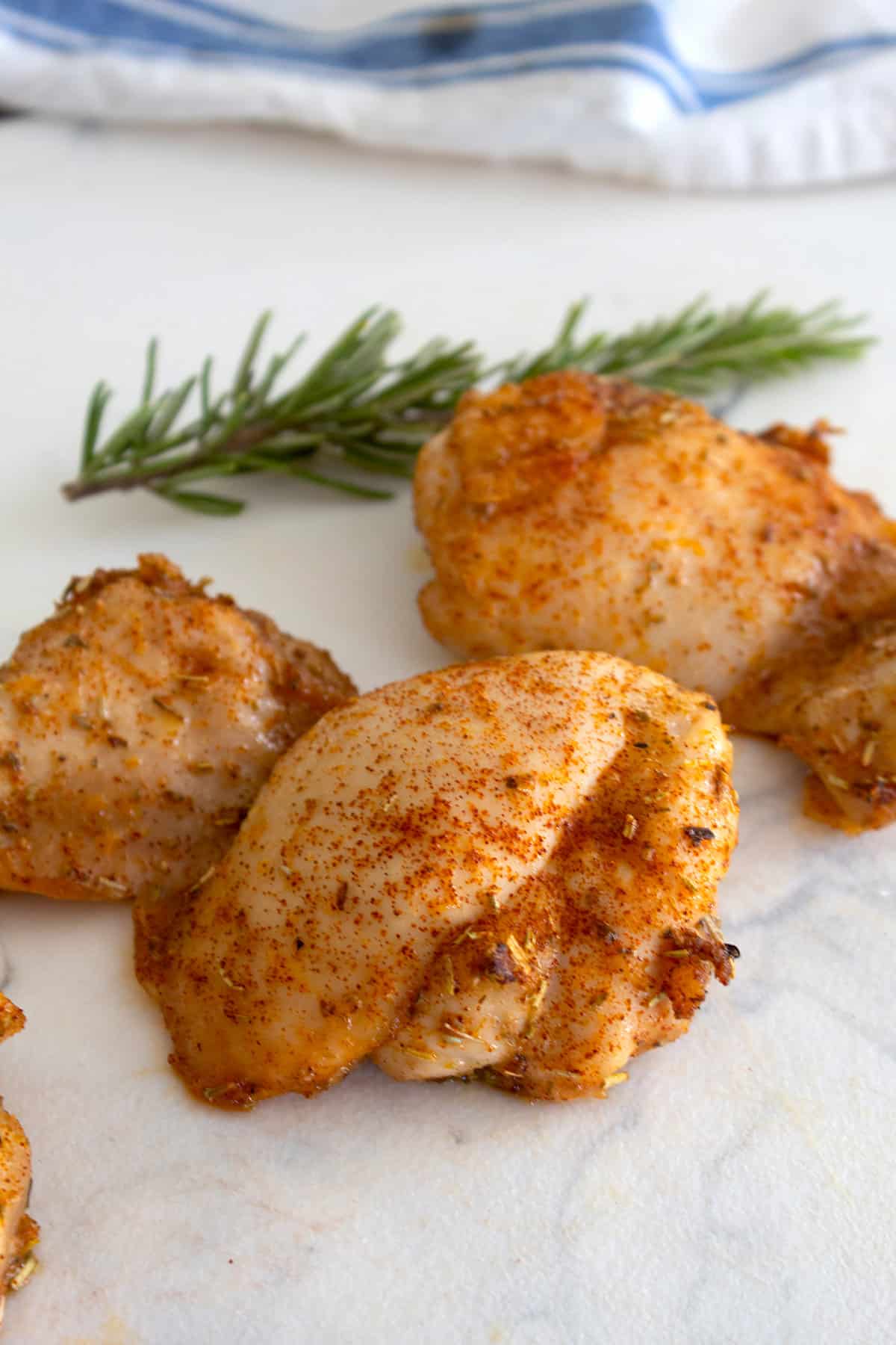 chicken thighs on a cutting board after being baked