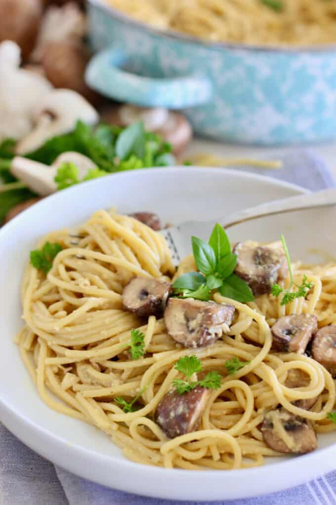pasta in a white bowl with mushrooms