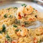 tuscan shrimp orzo dinner on a wooden spatula