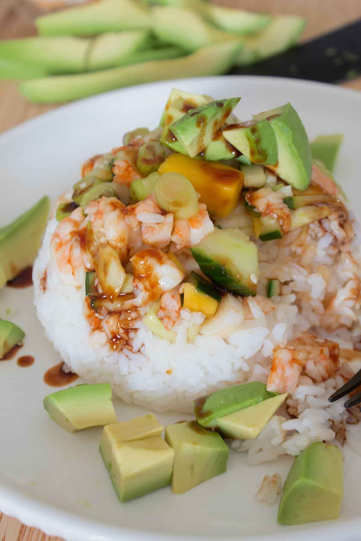 sushi stack on a white plate with teriyaki sauce