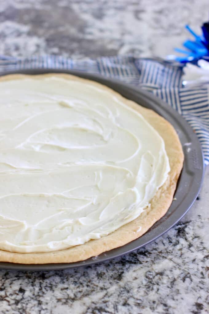 spread cream cheese onto baked cookie crust