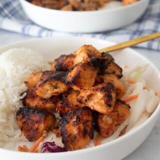 salmon bites in a bowl with rice and cabbage