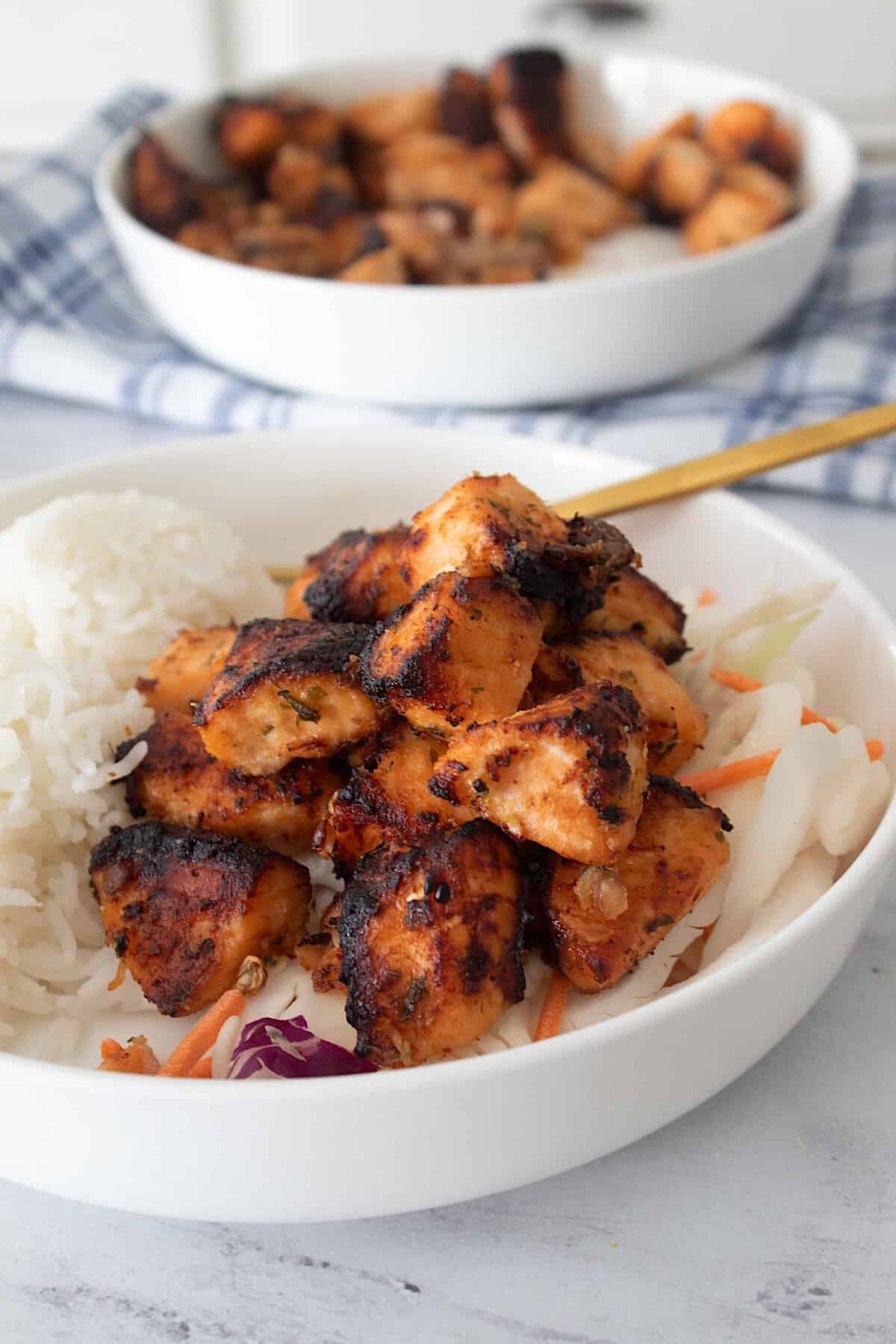 salmon bites in a bowl with rice and cabbage