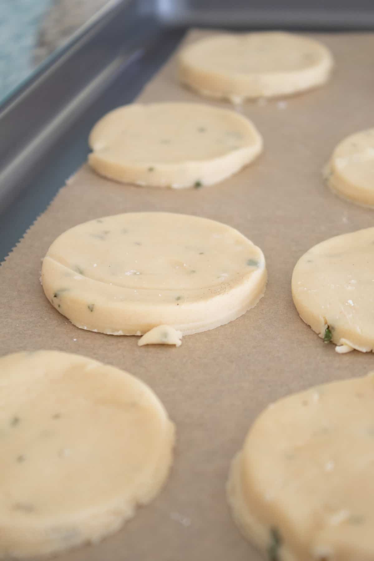 raw rosemary cookies on a baking sheet