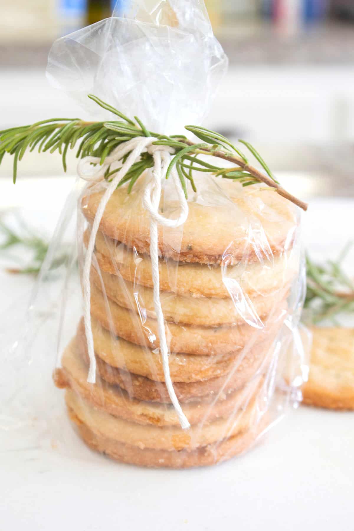 stack of rosemary cookies in cellophane bag tied with rosemary