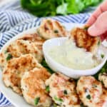 dipping chicken nuggets into basil aioli