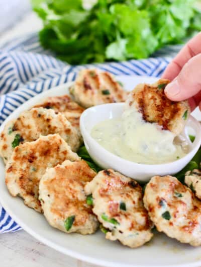 dipping chicken nuggets into basil aioli