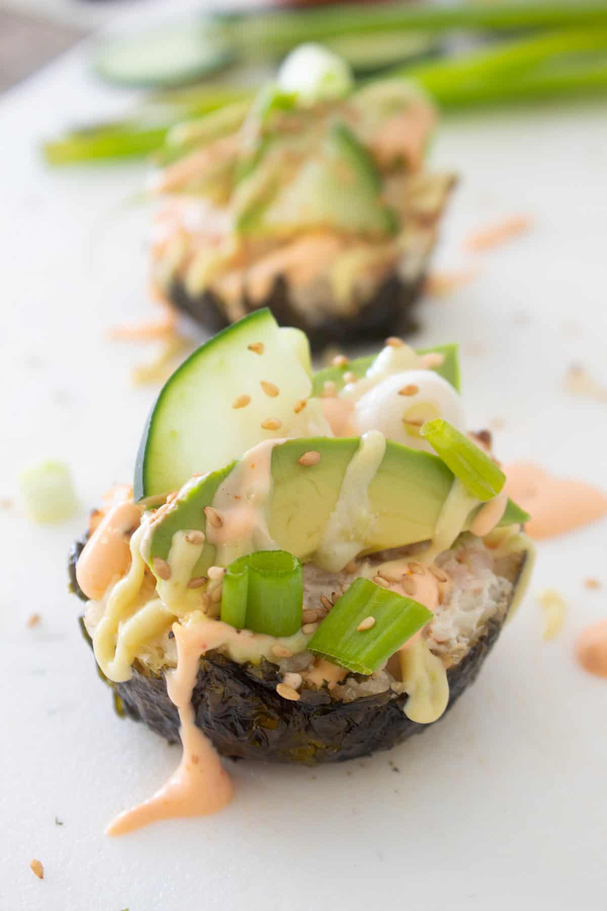 sushi cupcake with toppings on a white surface