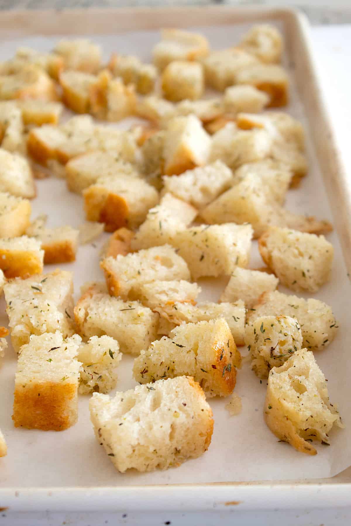 raw croutons on a baking sheet