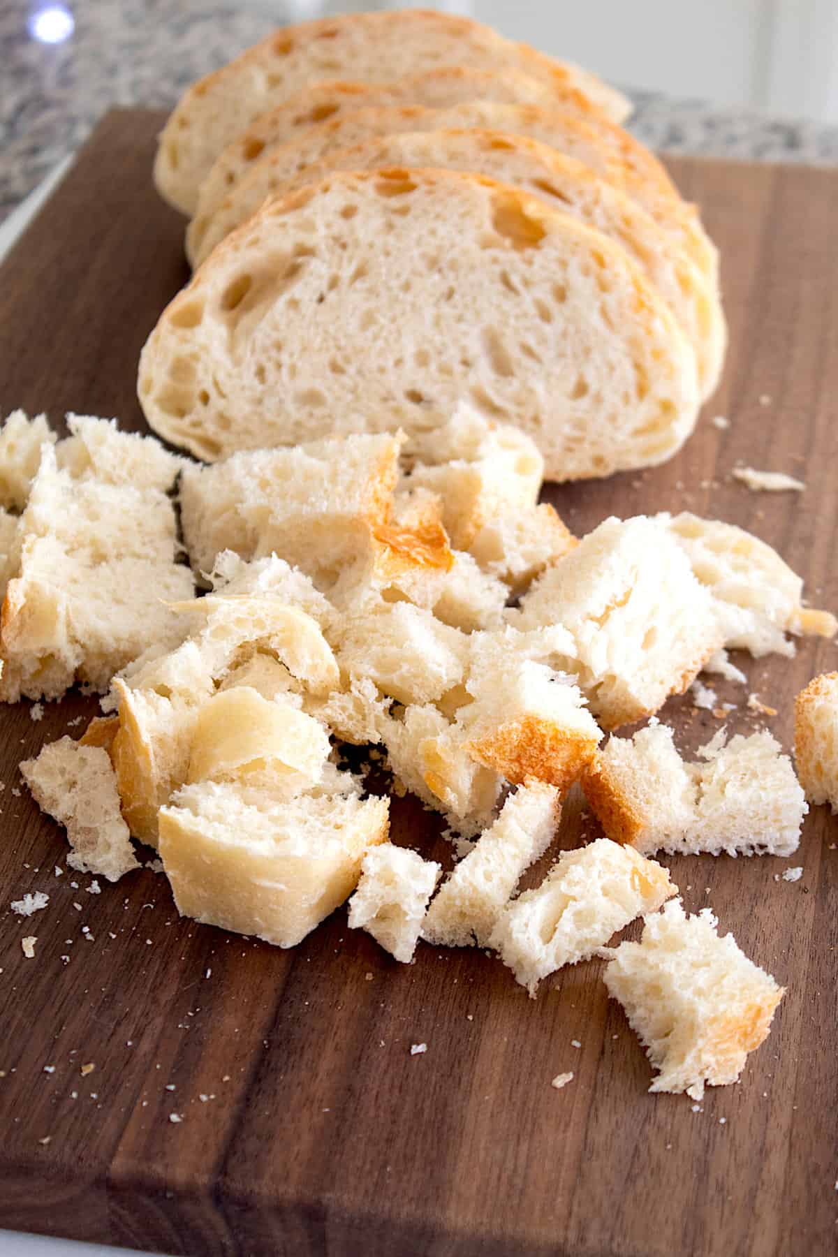 cubed bread on a cutting board