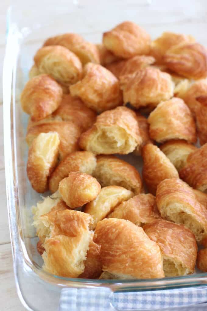 cut up croissants in a casserole dish
