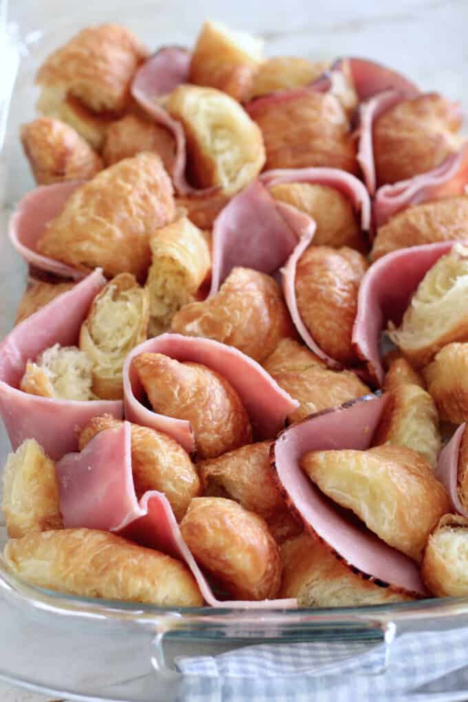 add deli ham slices around croissants