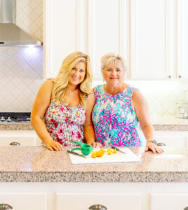 Kathi and Rachel Kirk in a kitchen in floral dresses