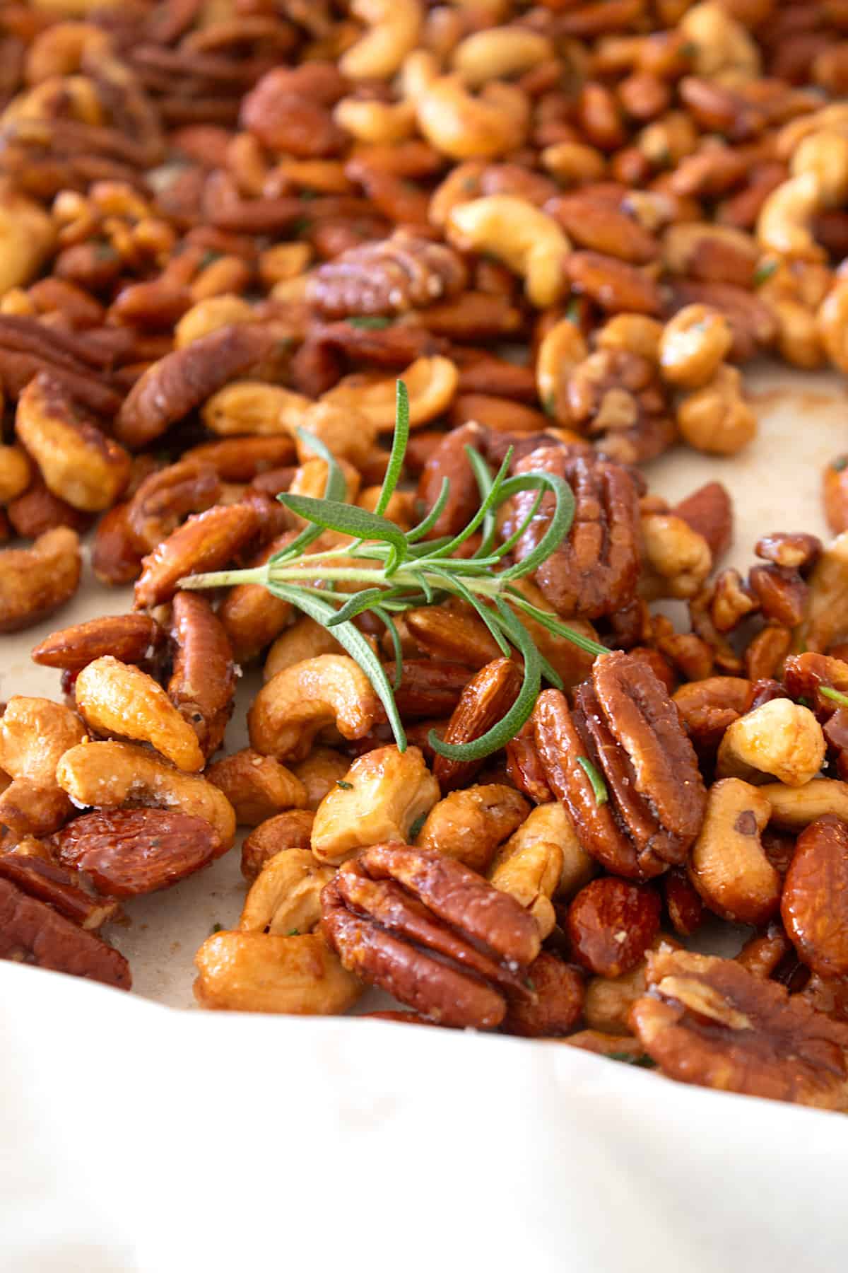 honey roasted nuts out of the oven on a baking sheet
