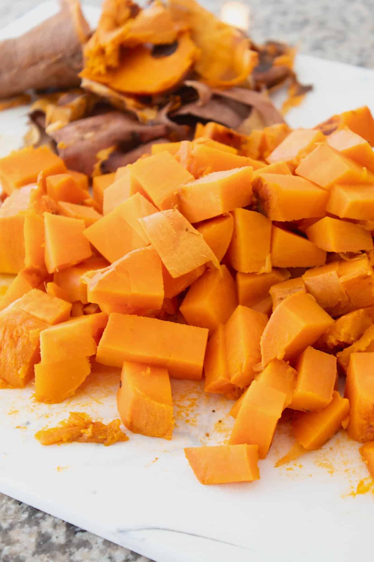 cubed sweet potatoes on a cutting board