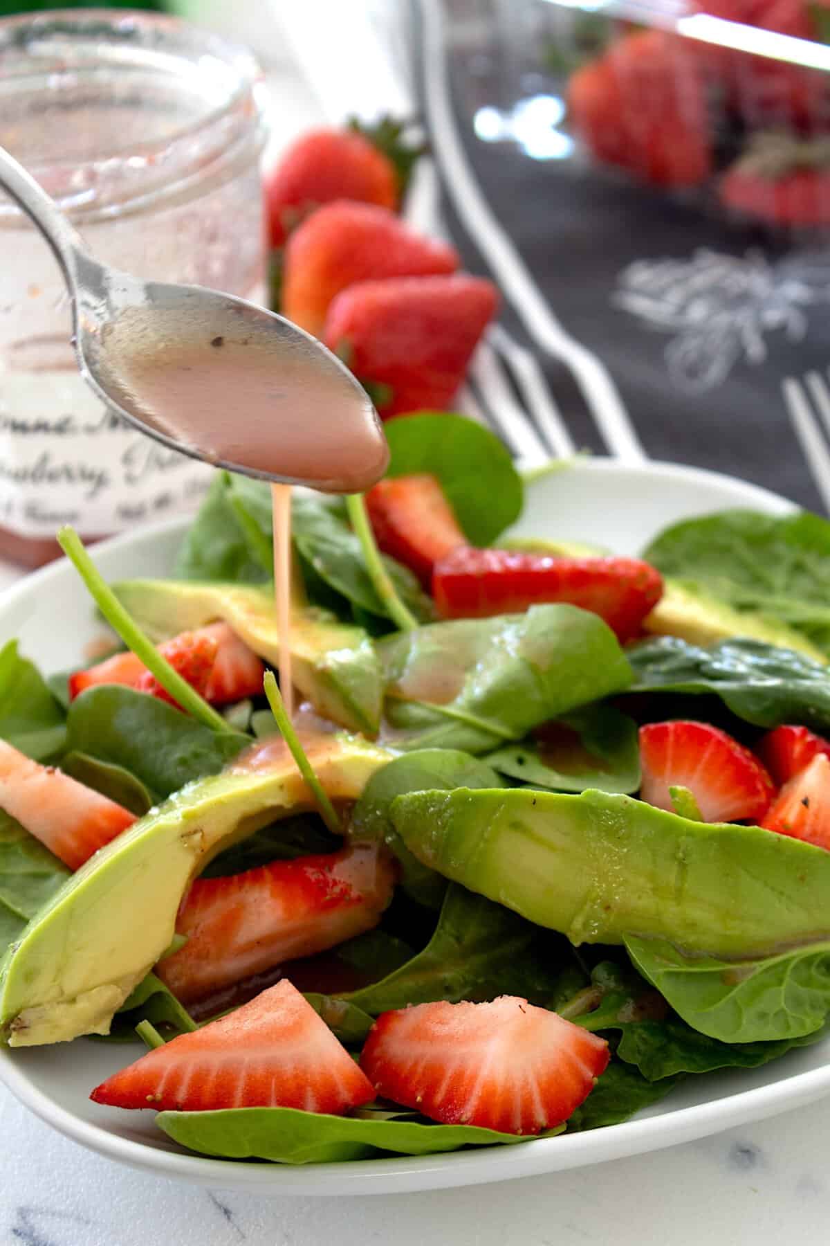drizzling dressing over salad