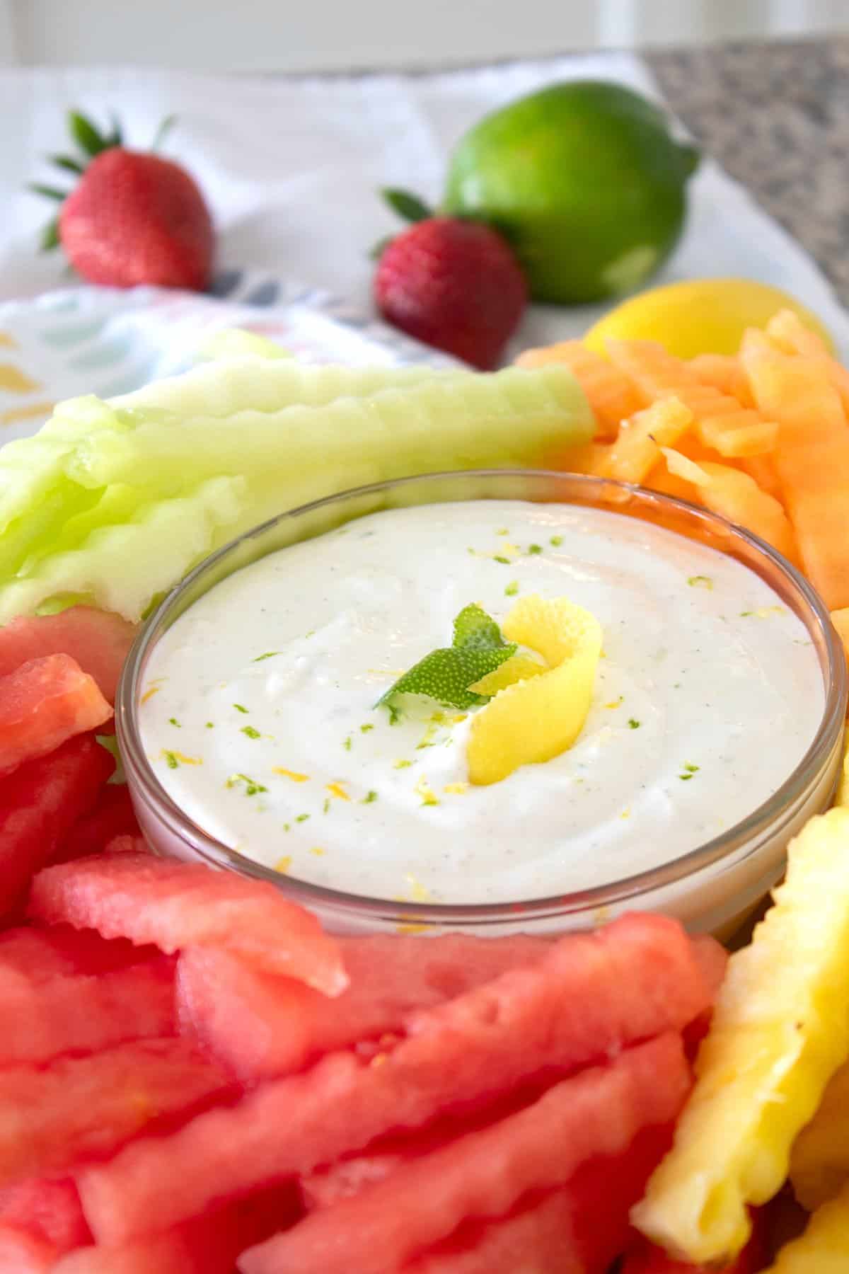 fruit dip surrounded by fruit on a platter