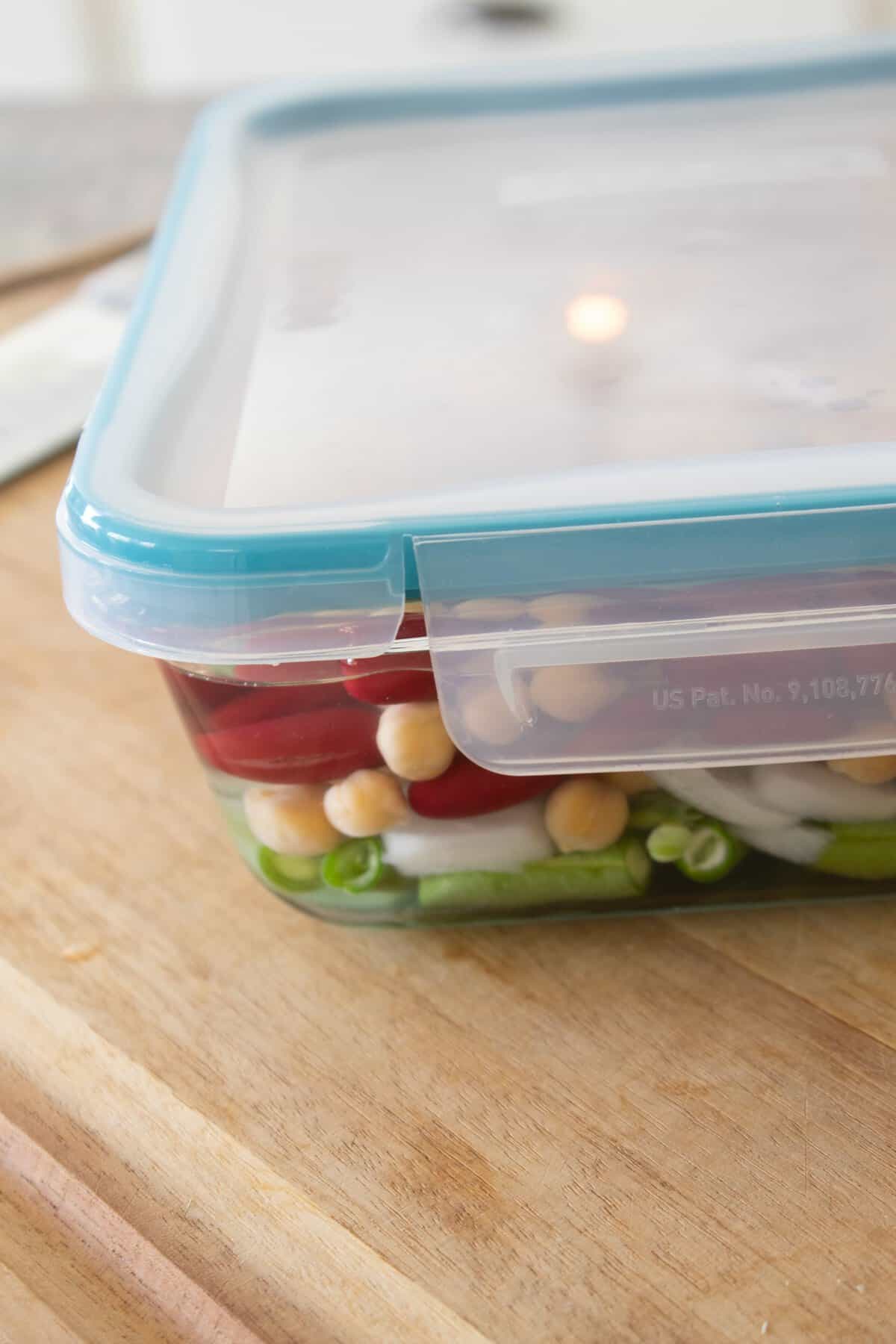 bean salad in a Tupperware dish 