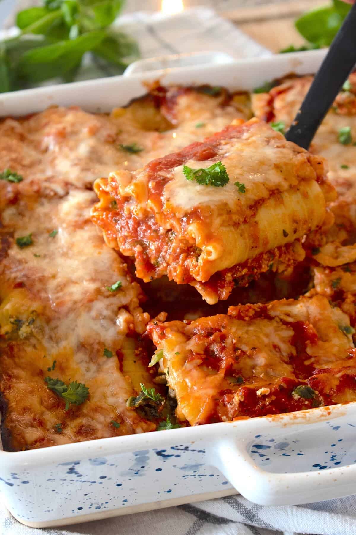 pan showing lasagna roll ups with spatula