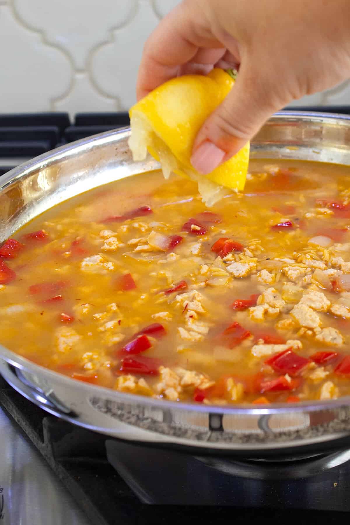 squeezing lemon into skillet