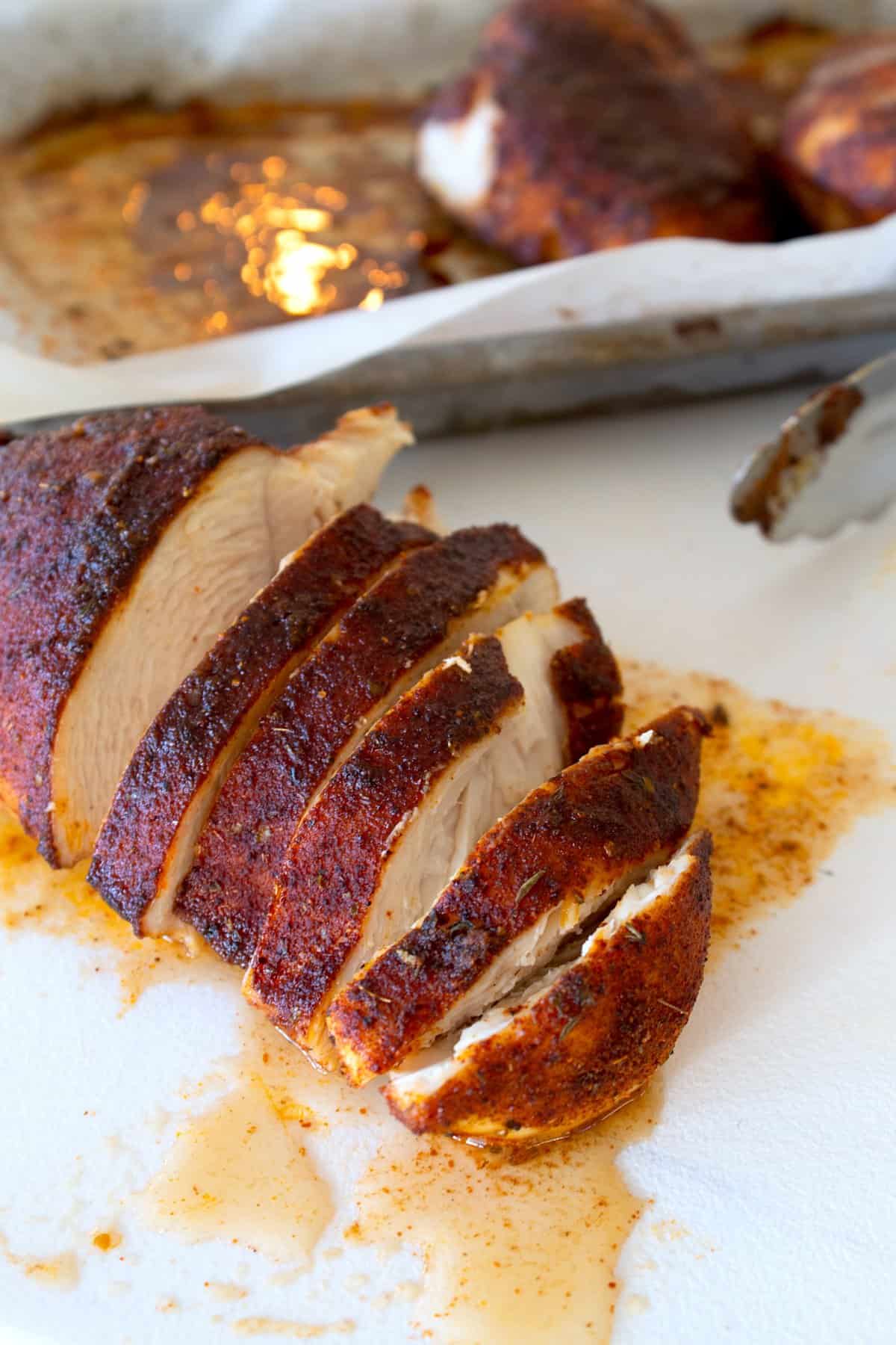 sliced blackened chicken on a cutting board