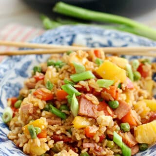 Pineapple Fried Rice with ham and veggies in a blue bowl