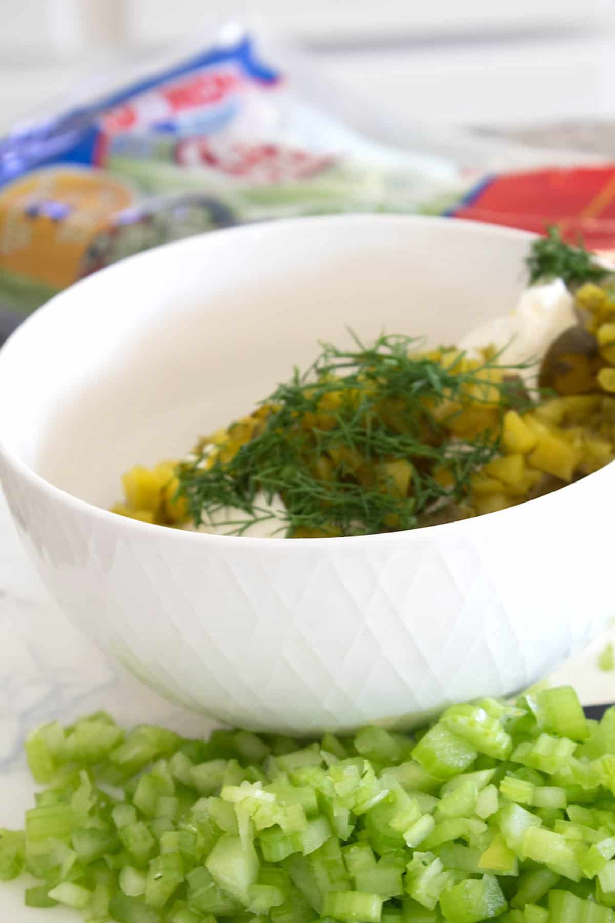 chopping celery to add to pickle dip