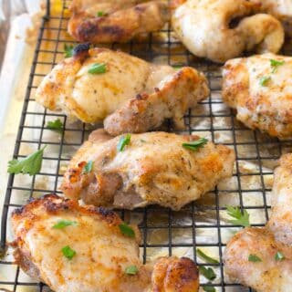overhead shot of baked chicken thighs on a pan