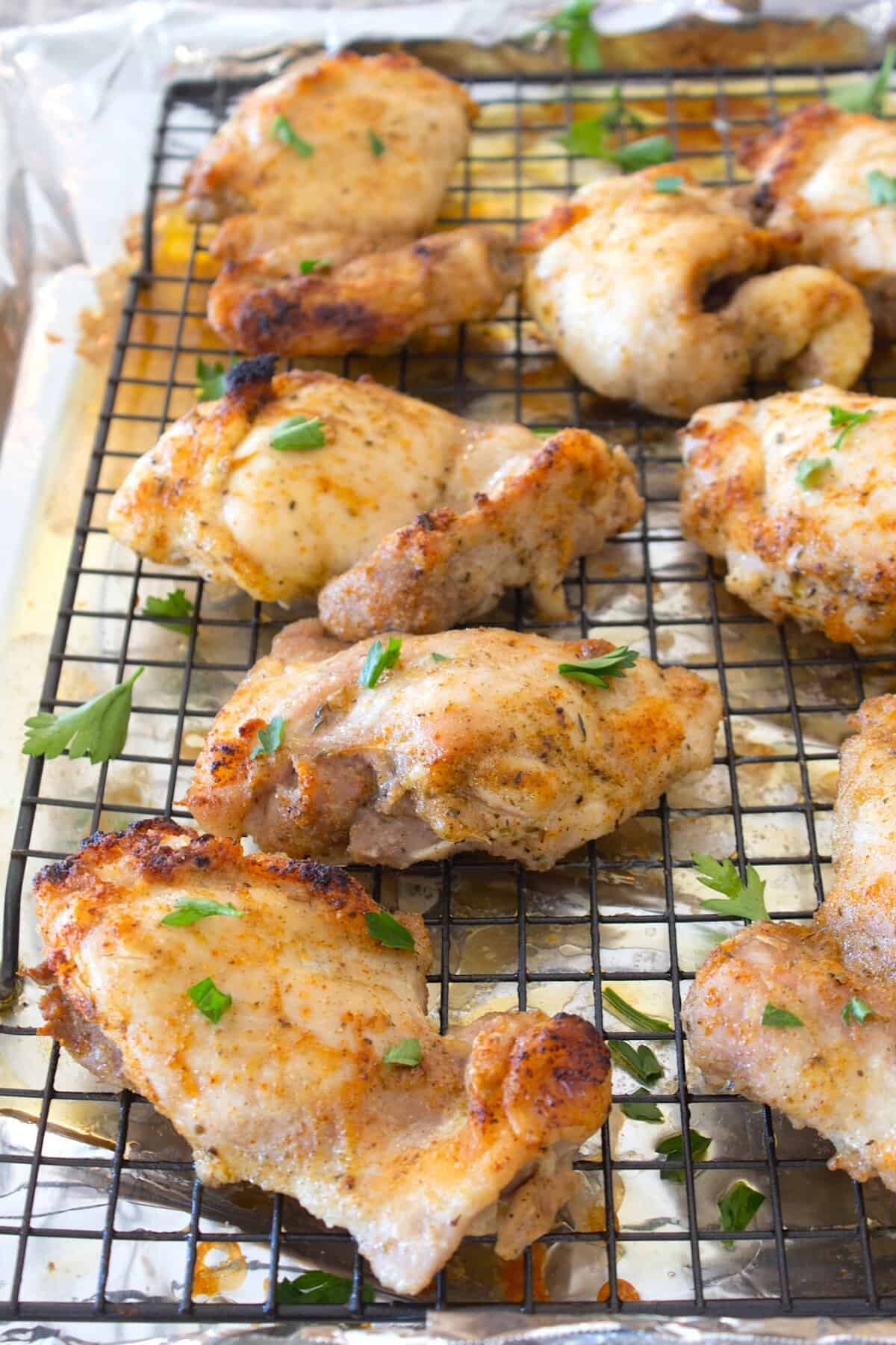 overhead shot of baked chicken thighs on a pan