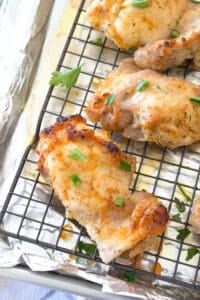 angled photo of chicken thighs baked on a sheet pan