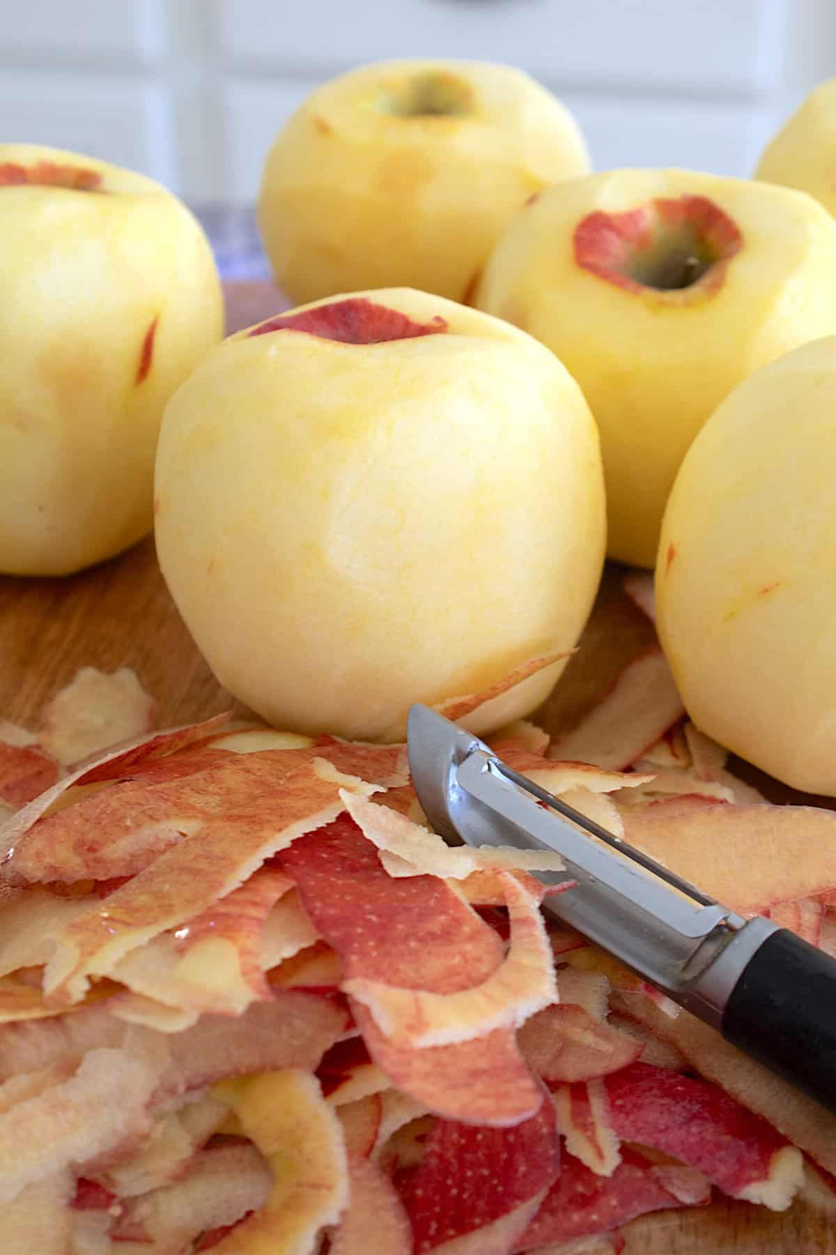 peeled apples on a cutting board