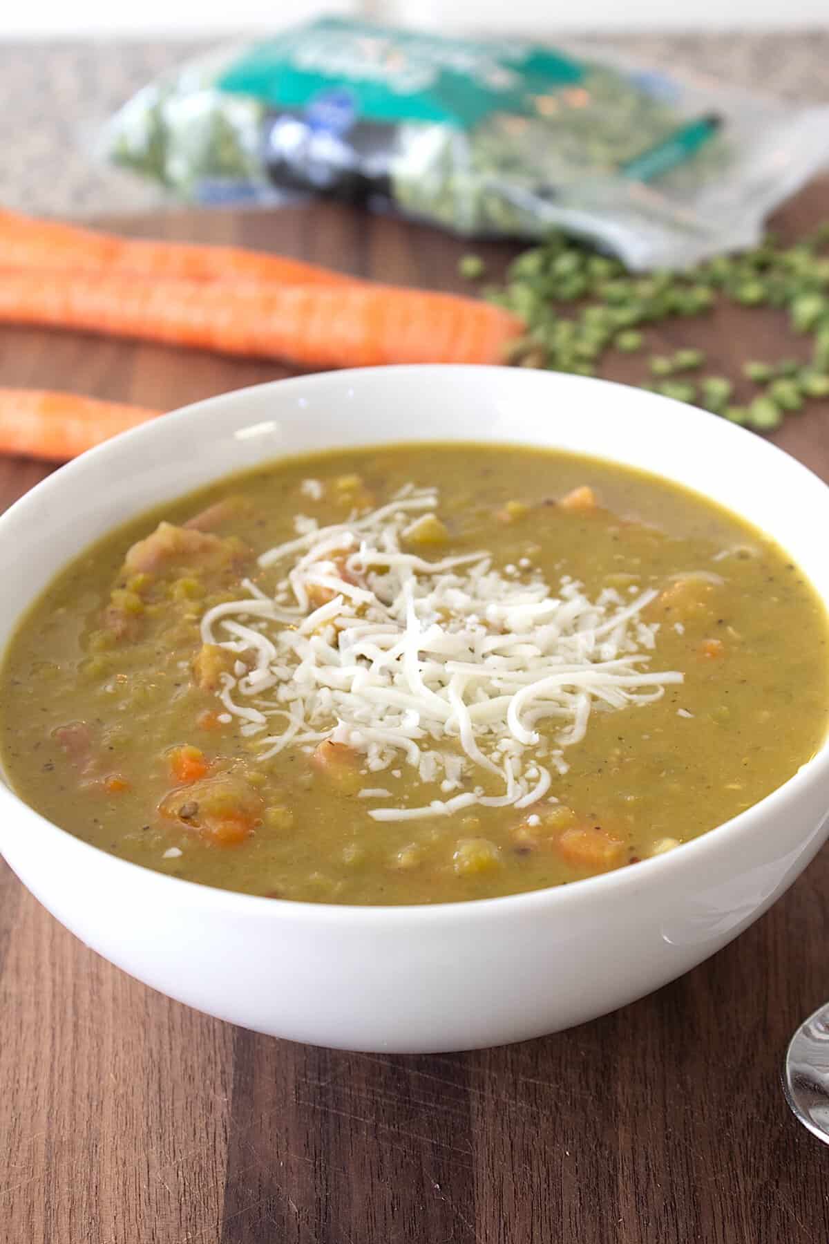 bowl of split pea soup with melted cheese