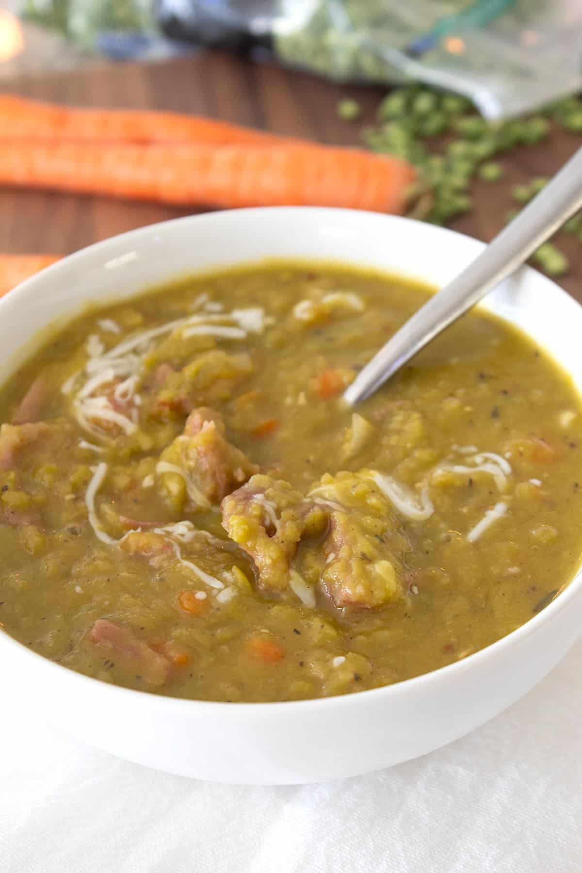 overhead shot of spoon in bowl of split pea soup