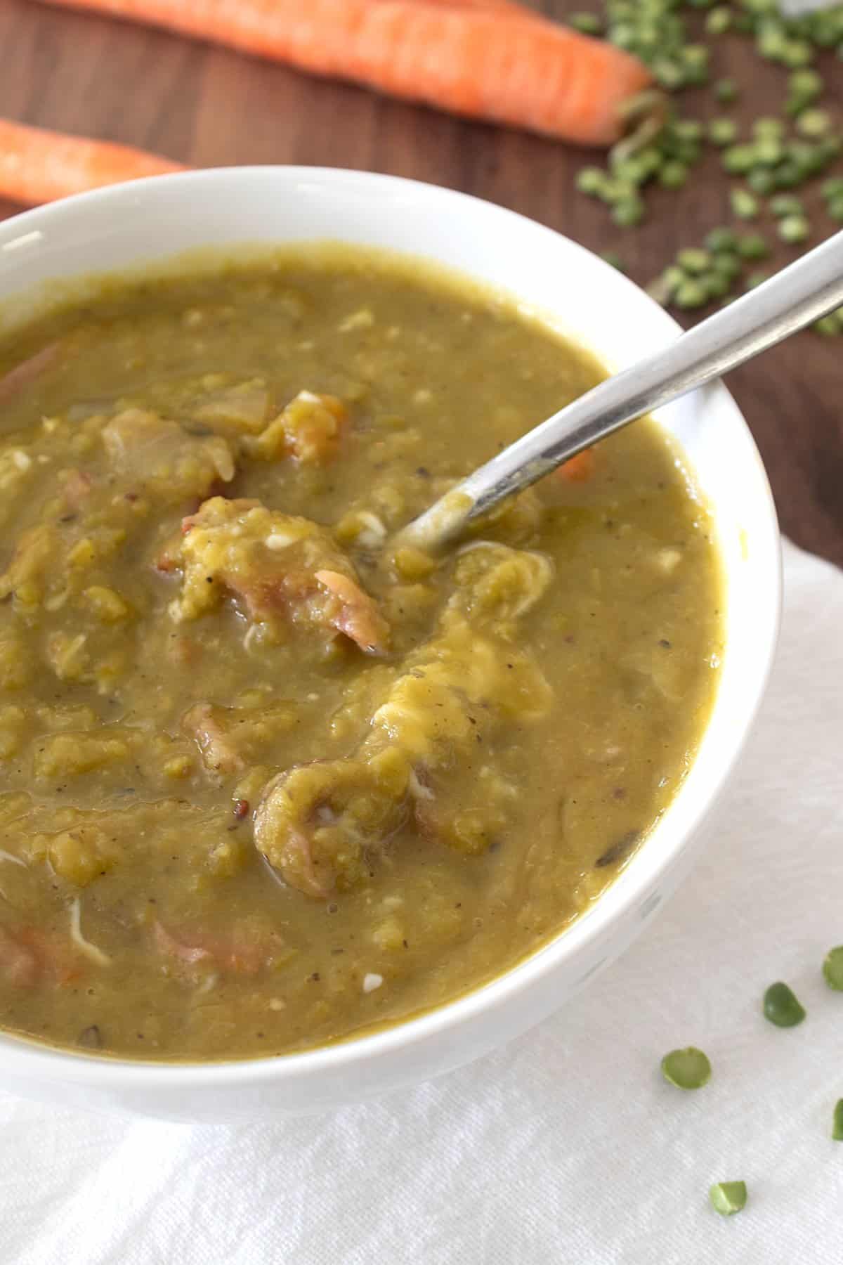 overhead view of split pea soup in white bowl