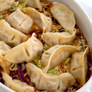 Overhead shot of baked wontons in a white casserole dish