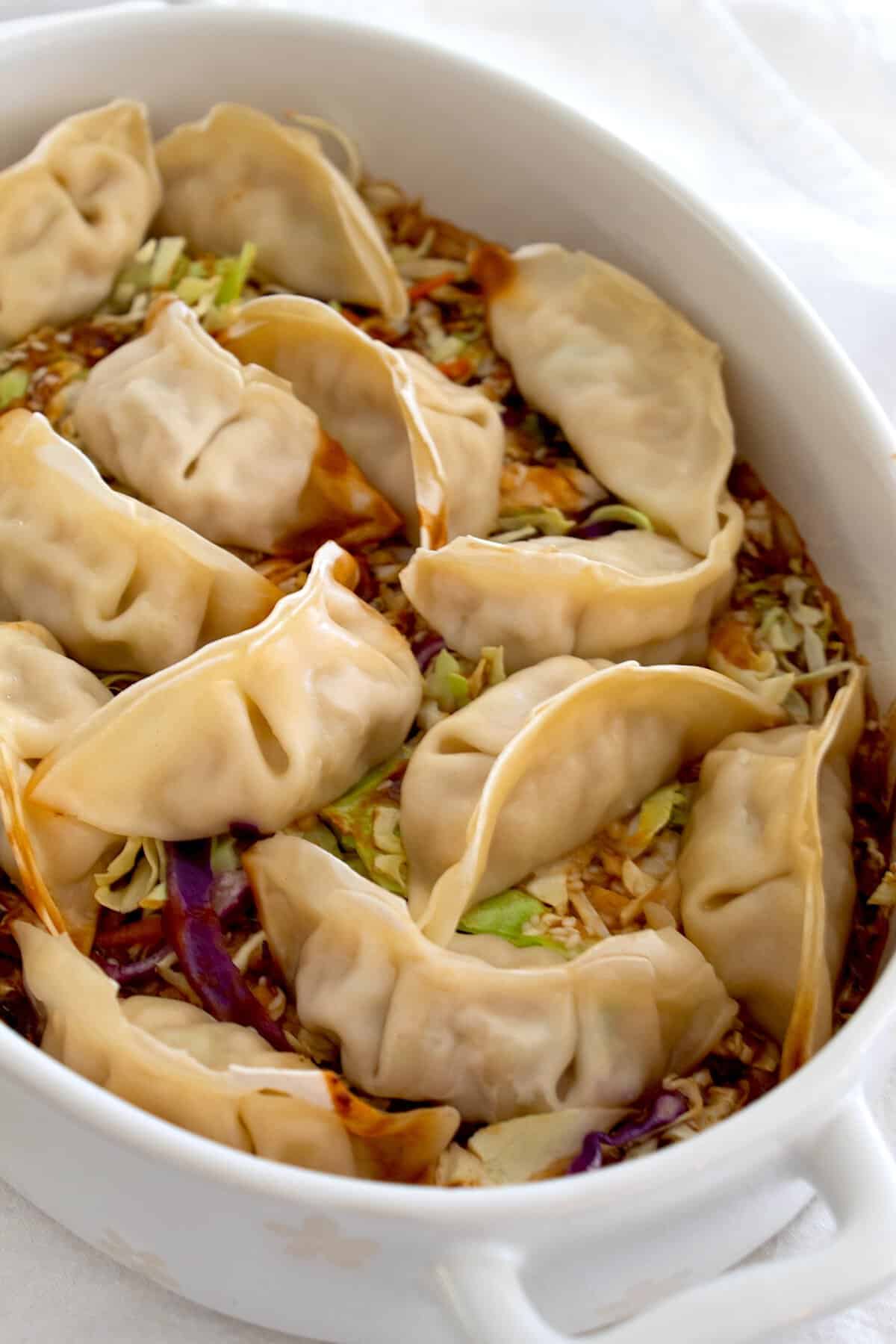 Overhead shot of baked wontons in a white casserole dish