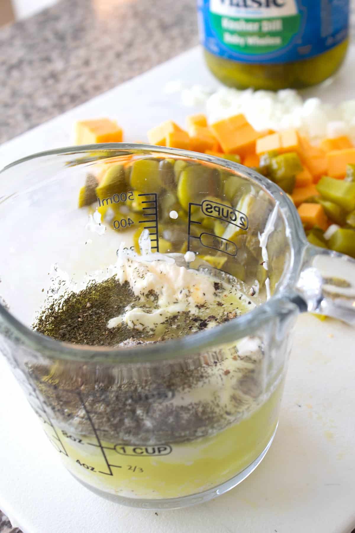 pickle dressing in a pyrex cup