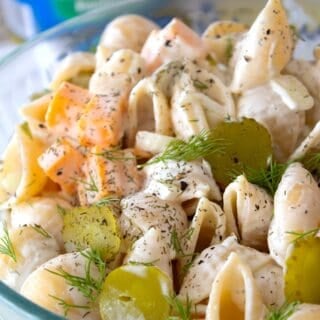 close up shot of pickle pasta salad in a clear bowl