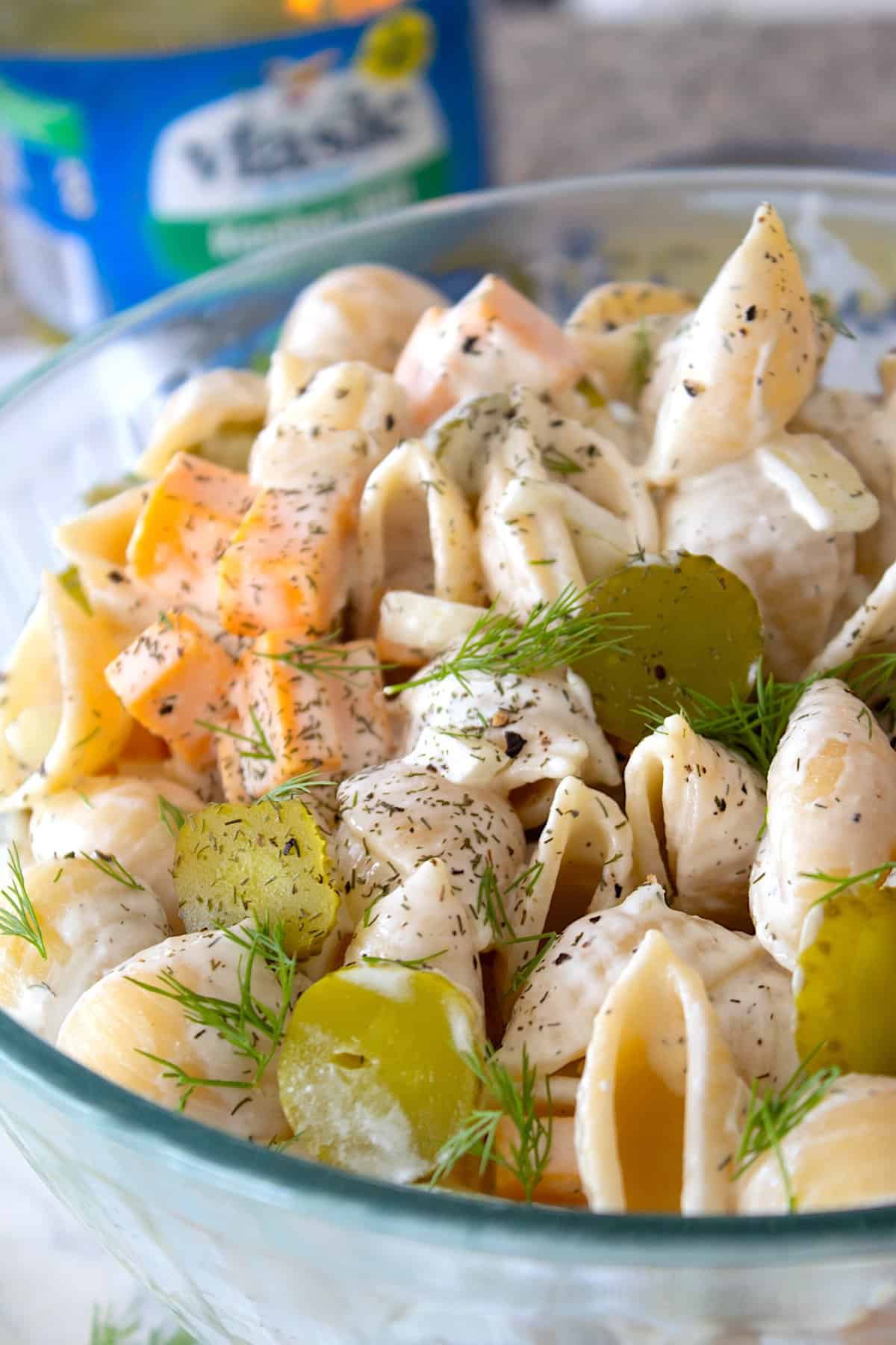 close up shot of pickle pasta salad in a clear bowl