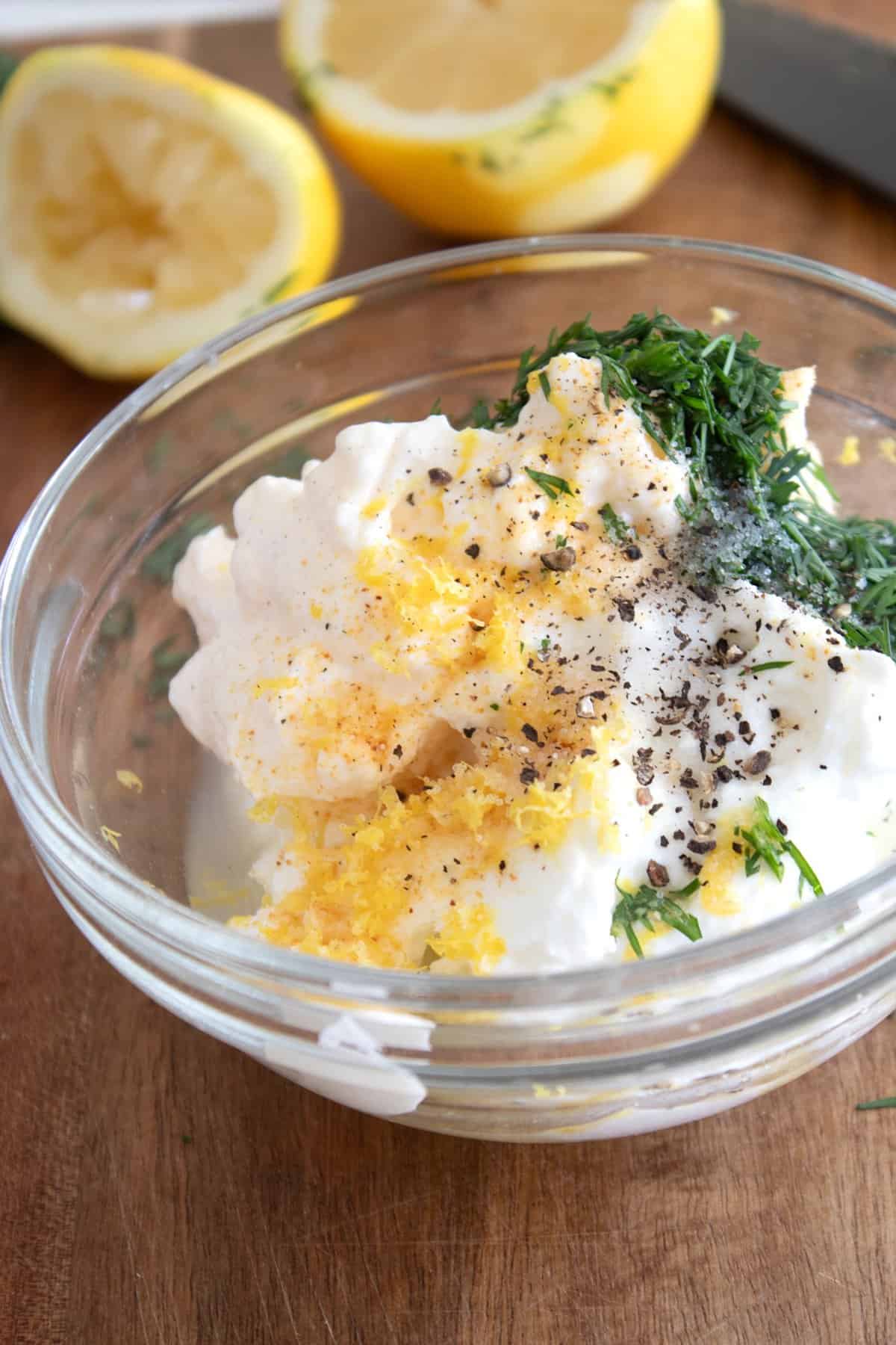 overhead view of dill sauce ingredients in a clear bowl