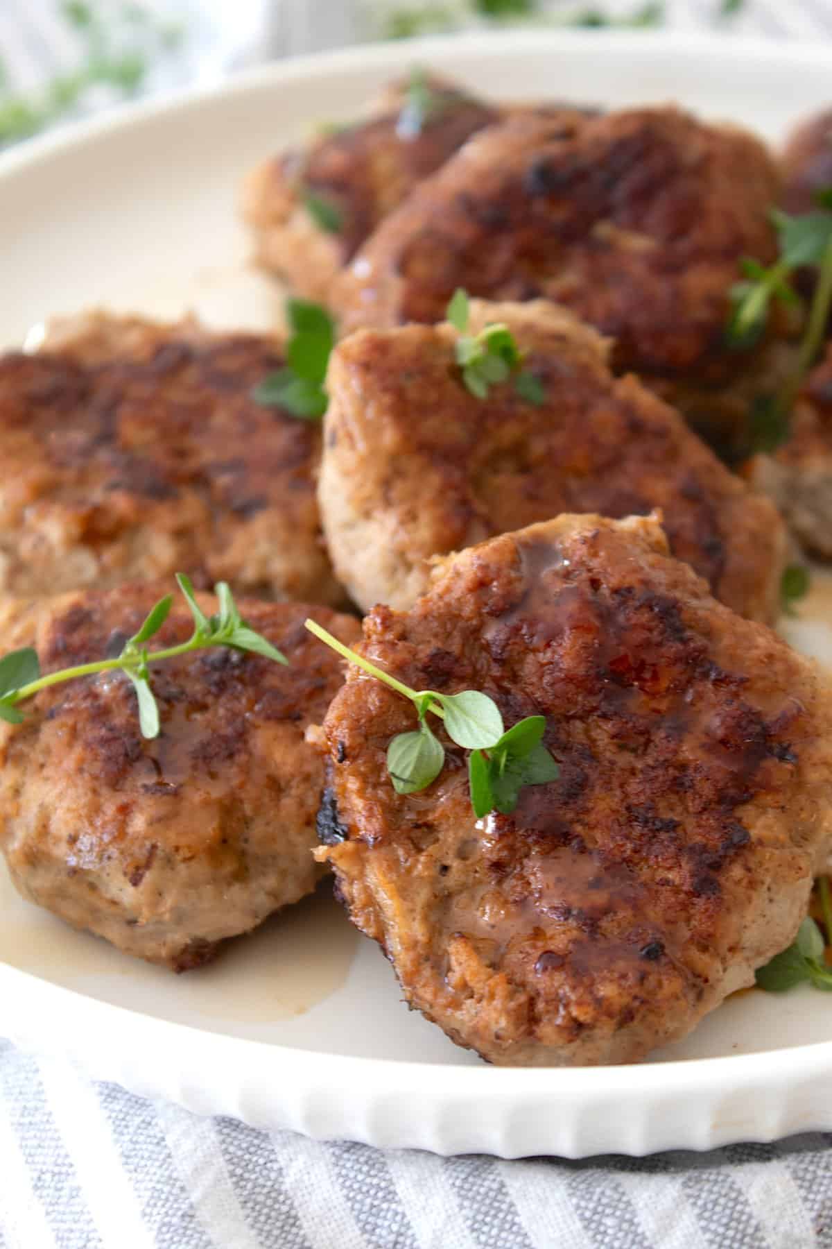 front view of turkey sausage patty garnished with thyme