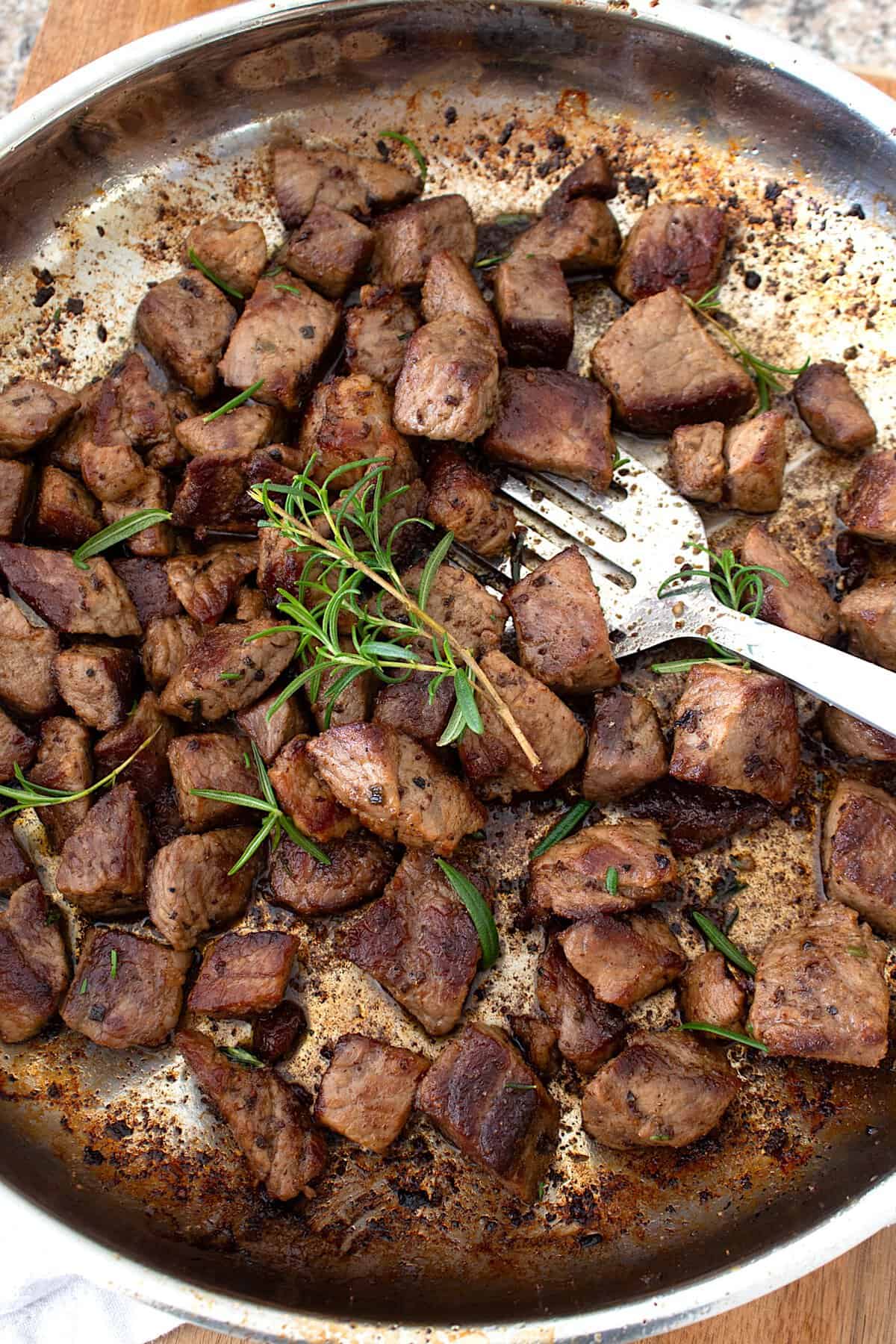 overhead view of steak bites in pan