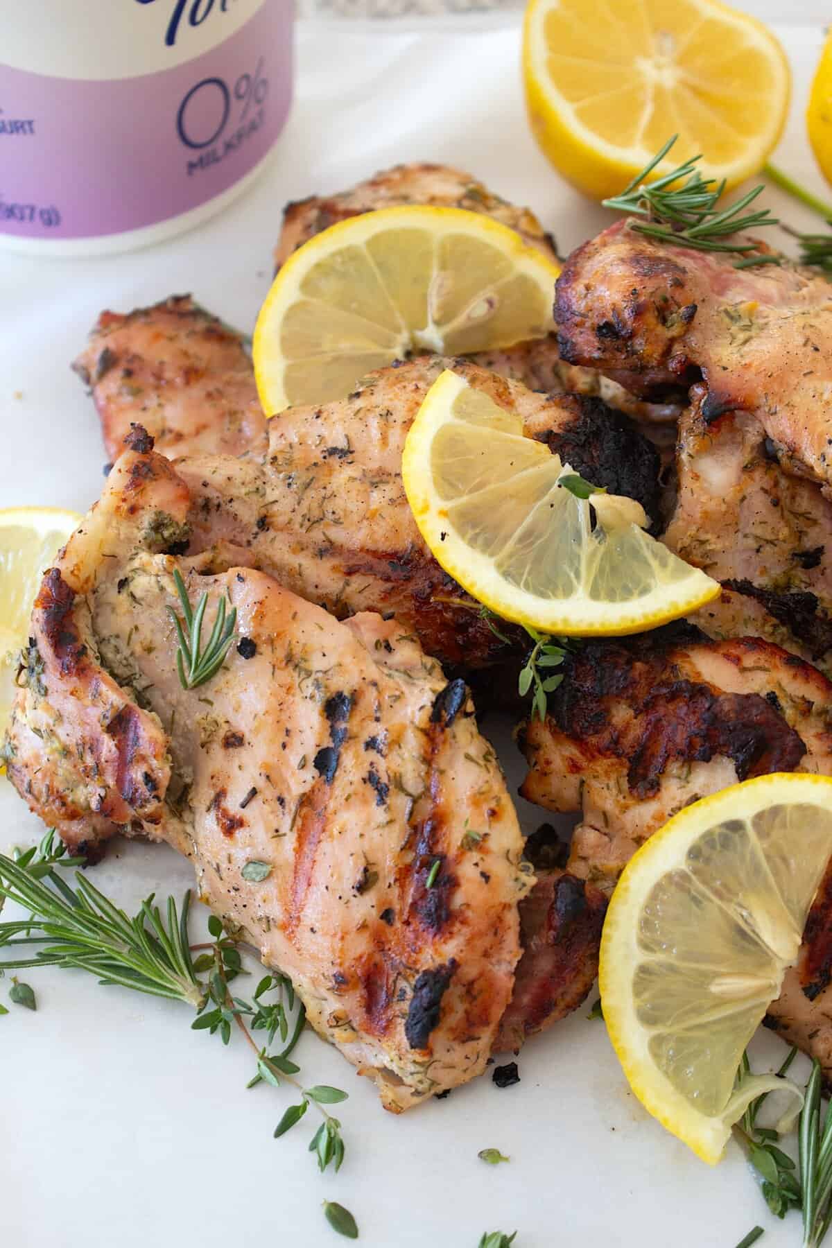overhead view of greek yogurt chicken with lemon garnish