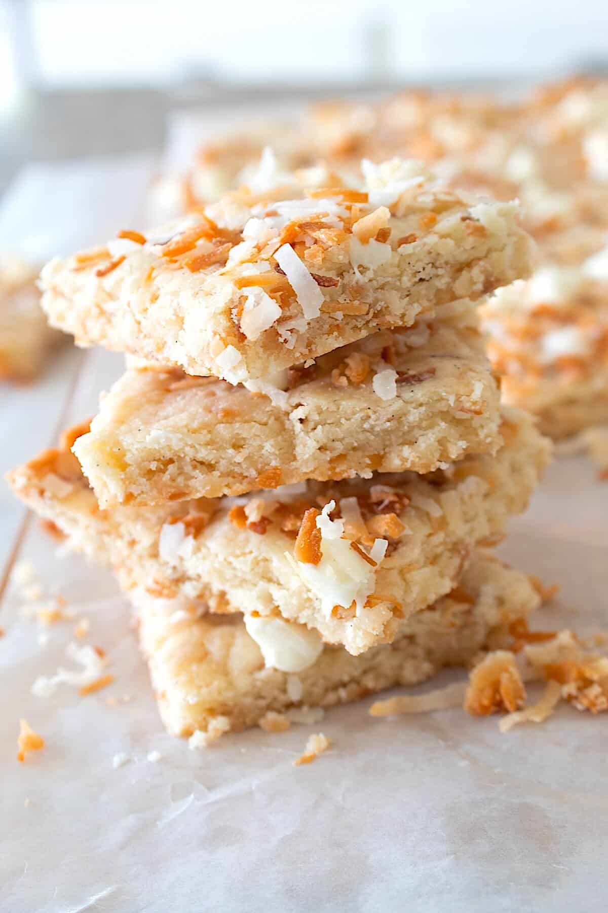 stacked coconut shortbread on parchment paper
