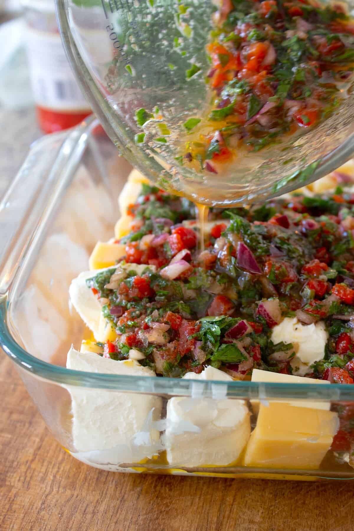 pouring cheese marinade over sliced cheese